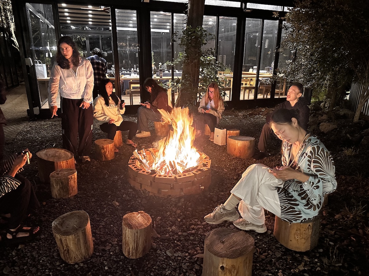 K-Pole Retreat participants enjoying their time together around a bond fire drinking and chatting.