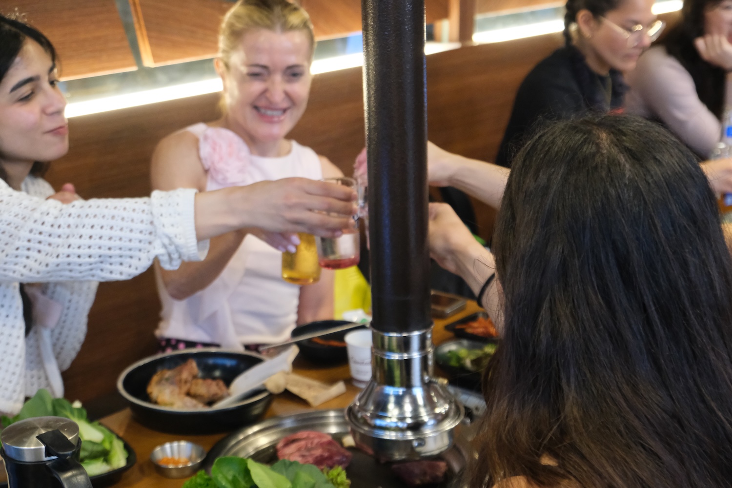 Cheers. K-Pole Retreat participants having BBQ dinner and drinks after a day of workshops in Seoul