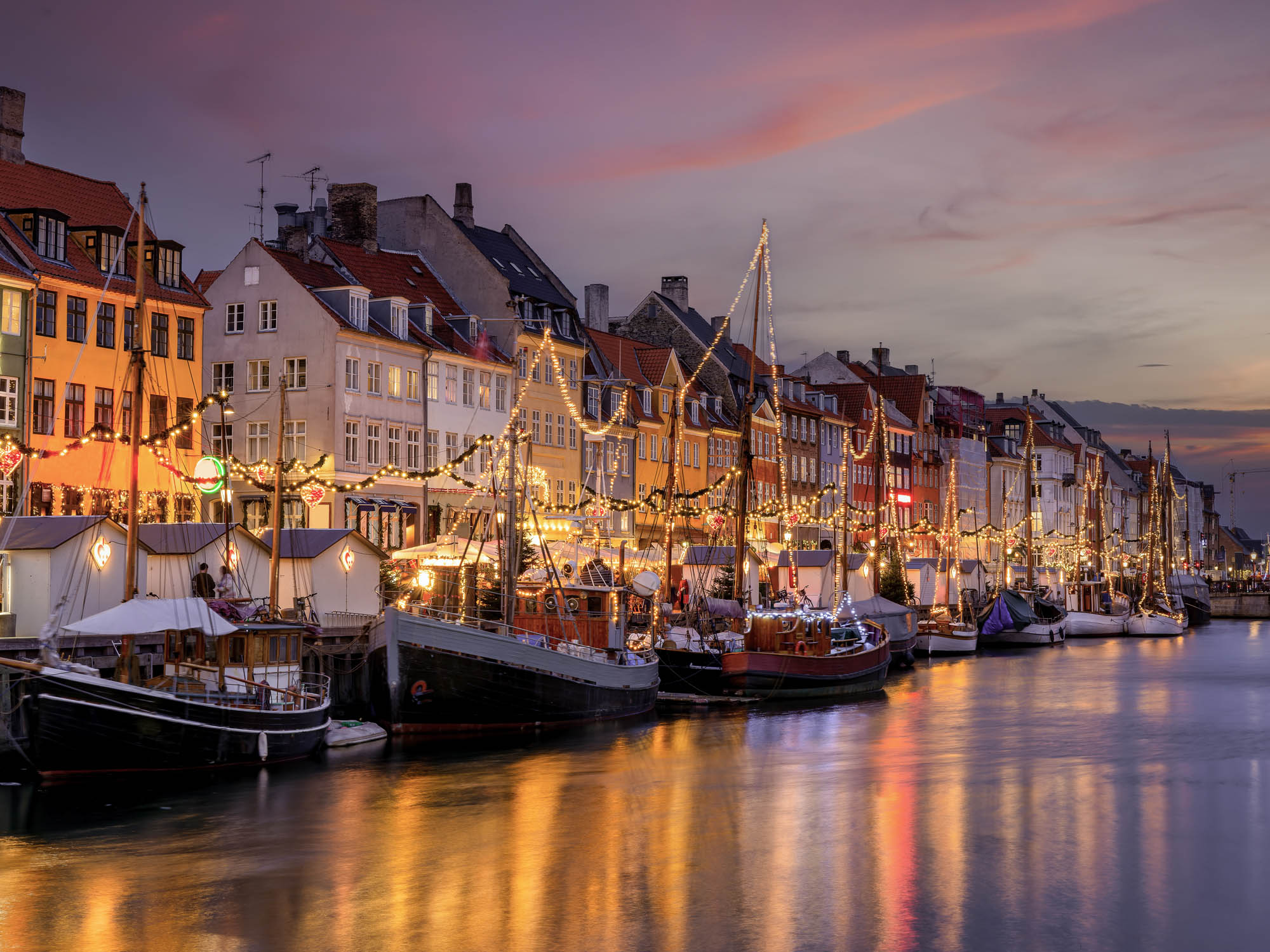 The baroque dome of Frederik’s Church rising above a golden-lit Copenhagen fountain, Denmark
