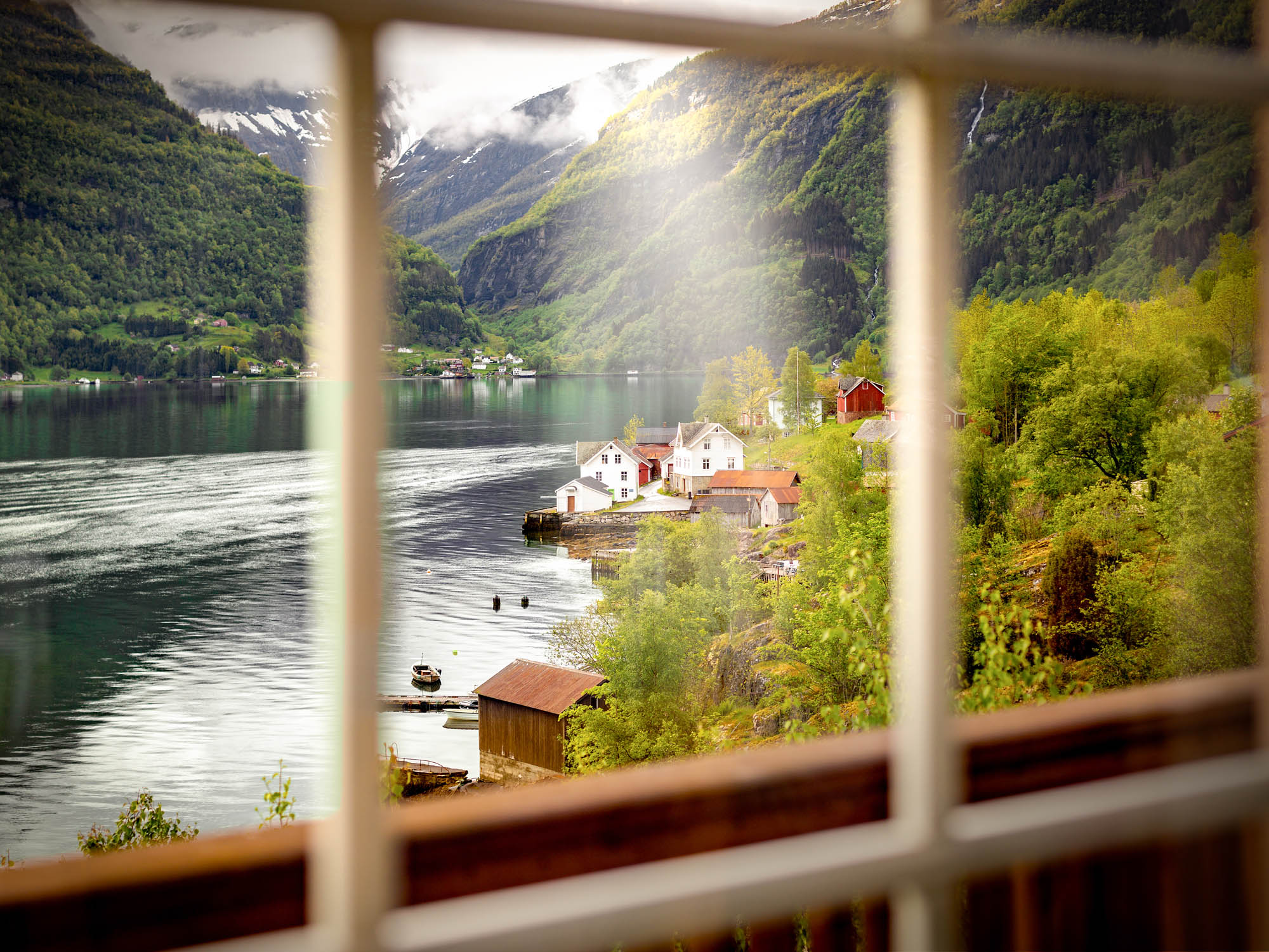 View across a Norwegian fjord valley framed through a scenic window