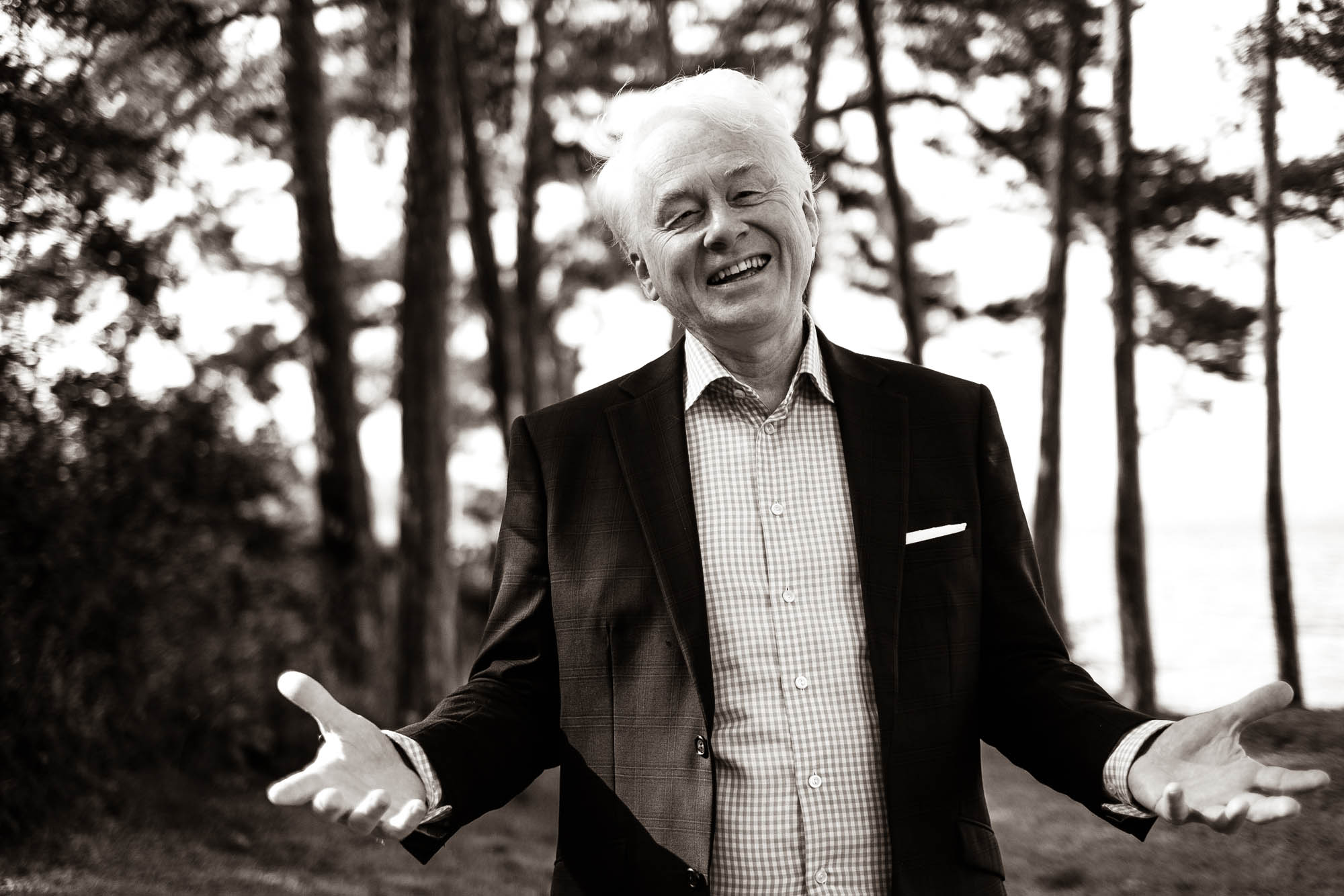 Jan Sortland, founder of Norwegian Adventures, smiling warmly against a Nordic woodland backdrop