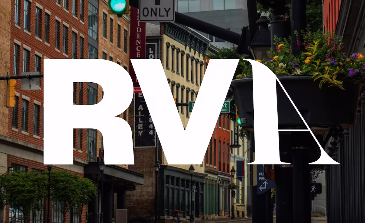 City street with brick buildings, traffic lights, and a large white RV A text overlay.