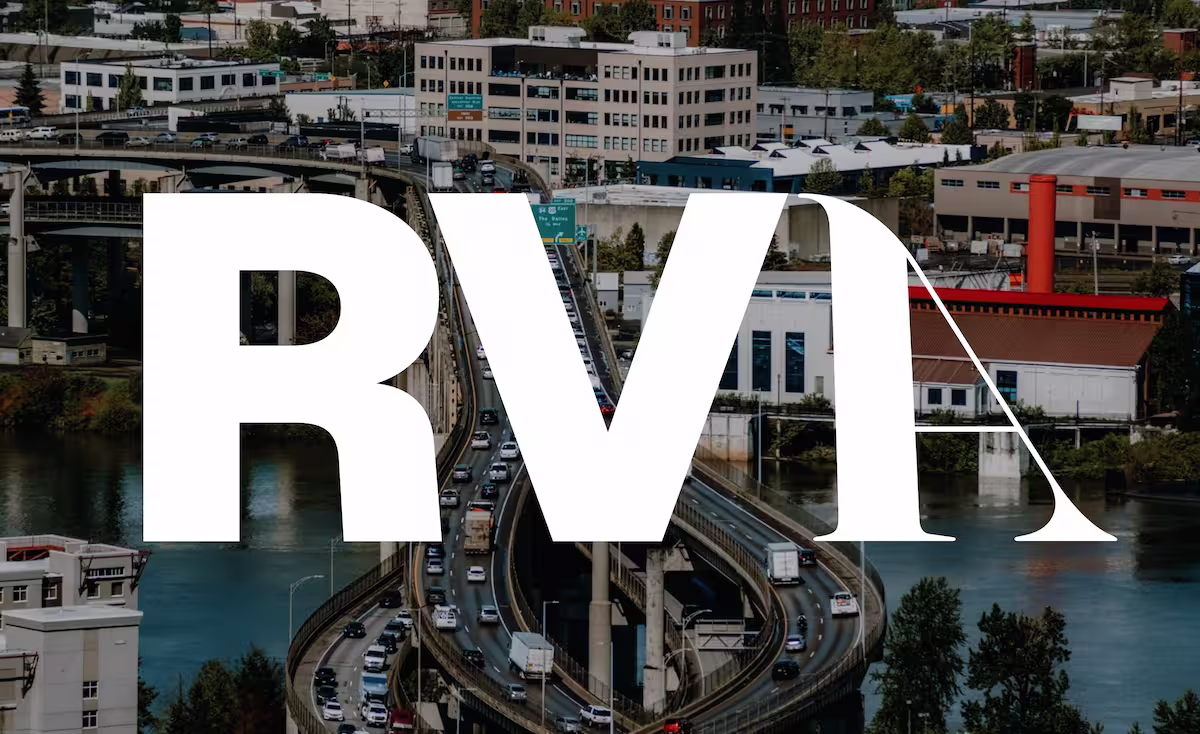 City view with highway over a river and large white RVA letters overlaying the scene.