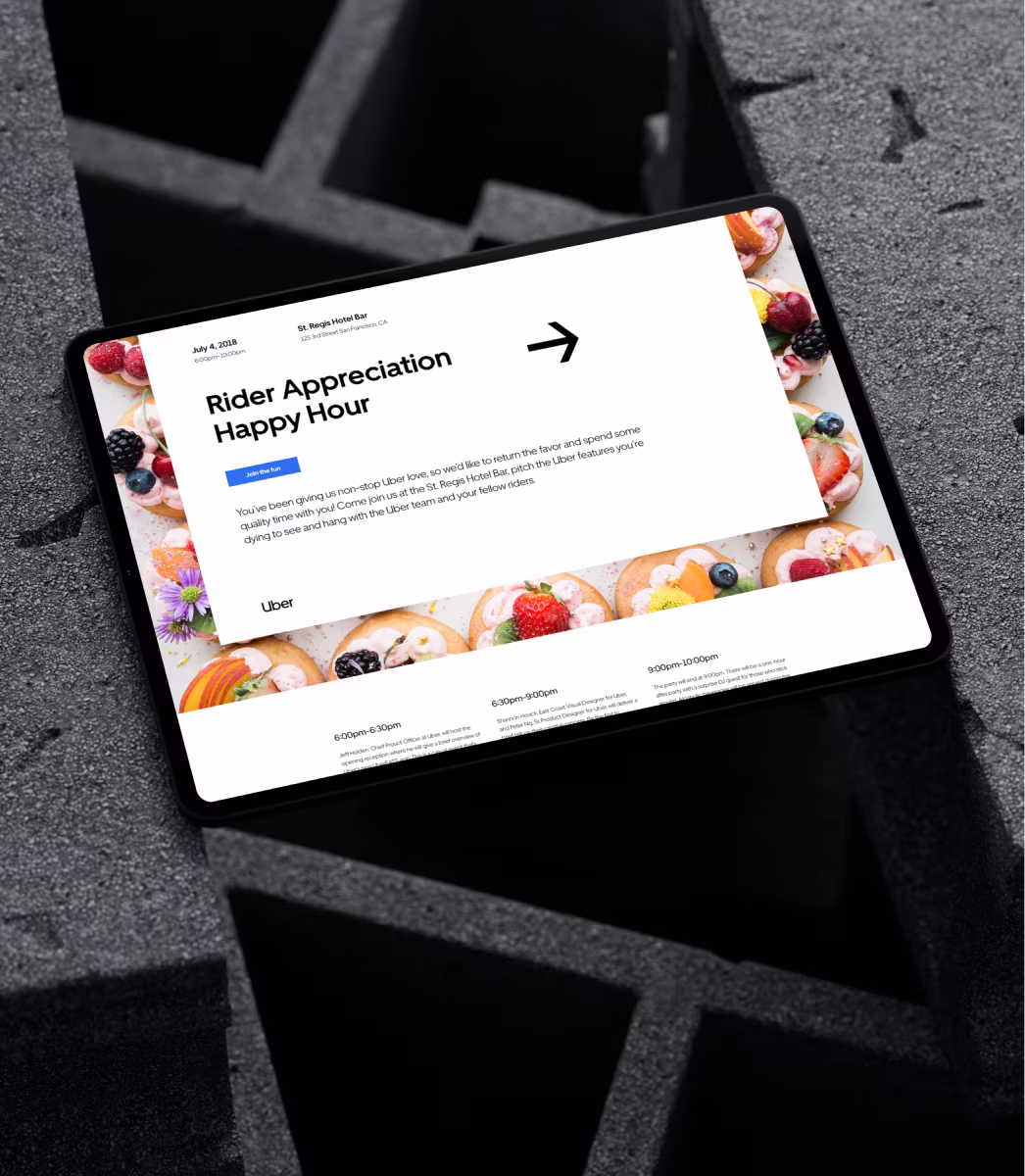 Tablet showing Uber Rider Appreciation Happy Hour event details with a fruit tart border on black foam blocks.