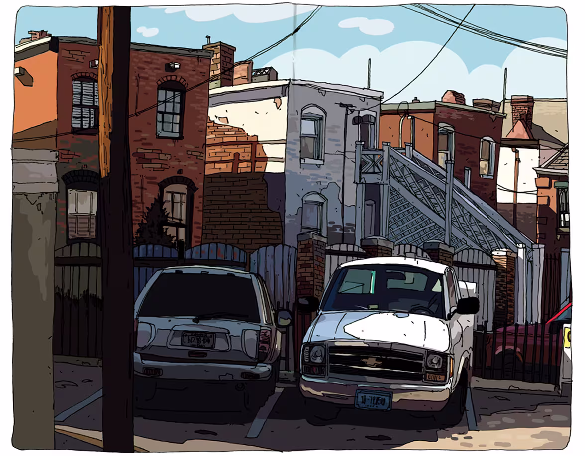 Two white vehicles parked in front of brick and gray buildings with an outdoor staircase on a sunny day.