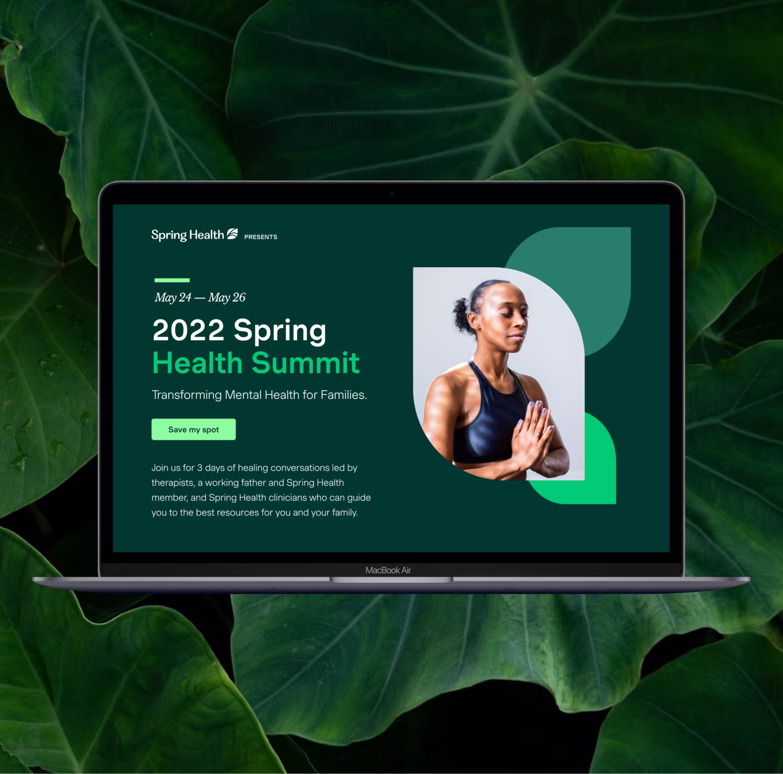 Laptop screen showing 2022 Spring Health Summit event details and a woman meditating with hands in prayer pose.