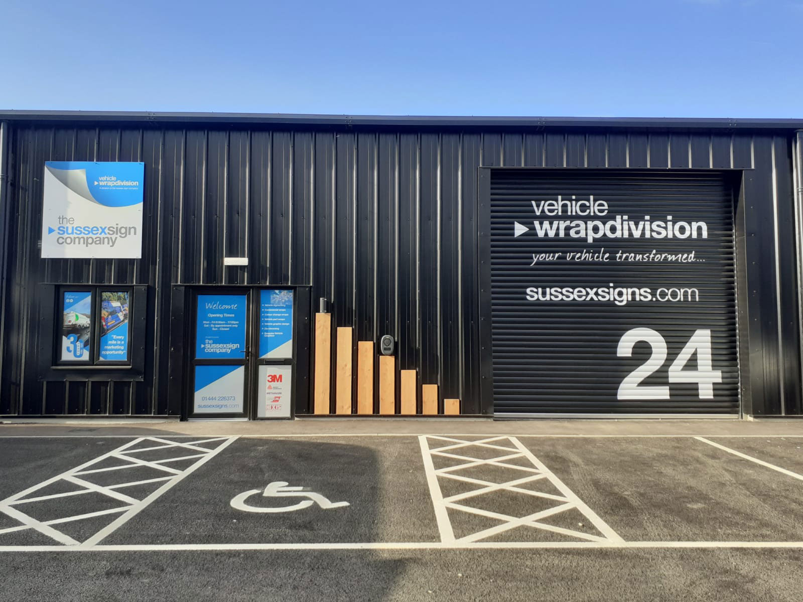 The exterior of the sussex sign companies wrap building