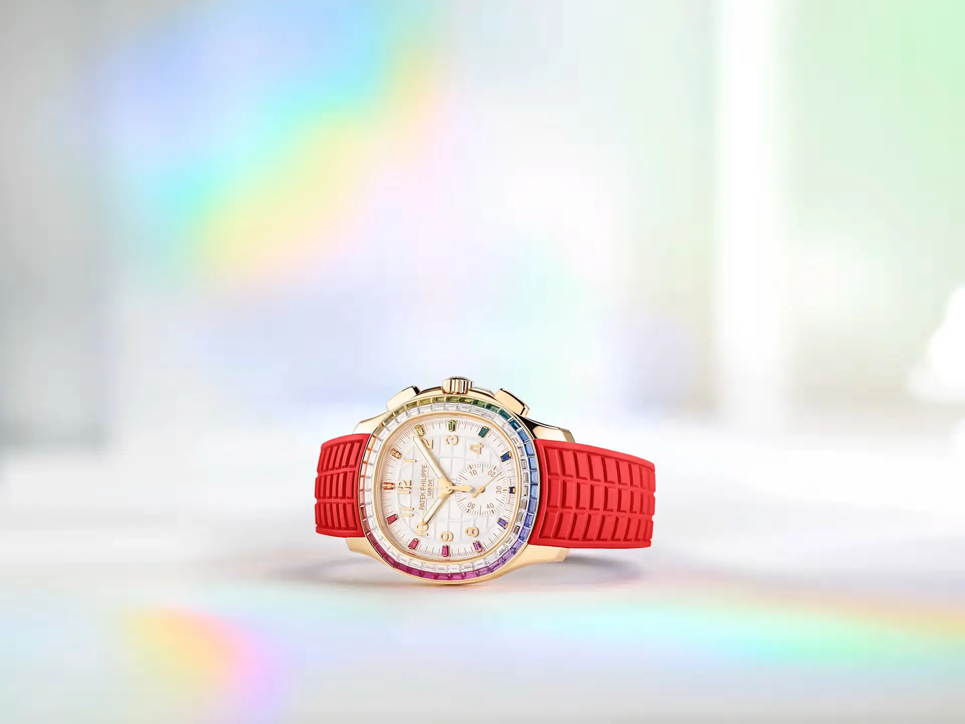Luxury wristwatch with a red rubber strap, gold case, and white dial adorned with multicolored gemstones around the bezel.