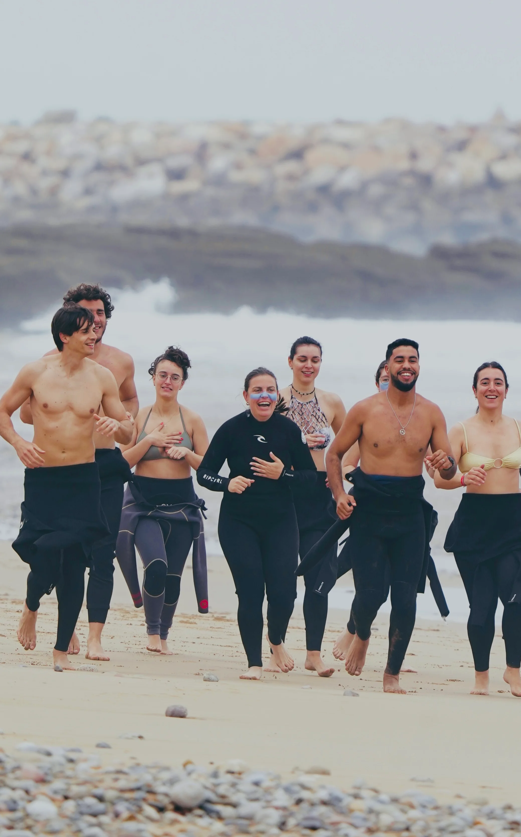 Surfers carrying boards on Tamraght beach