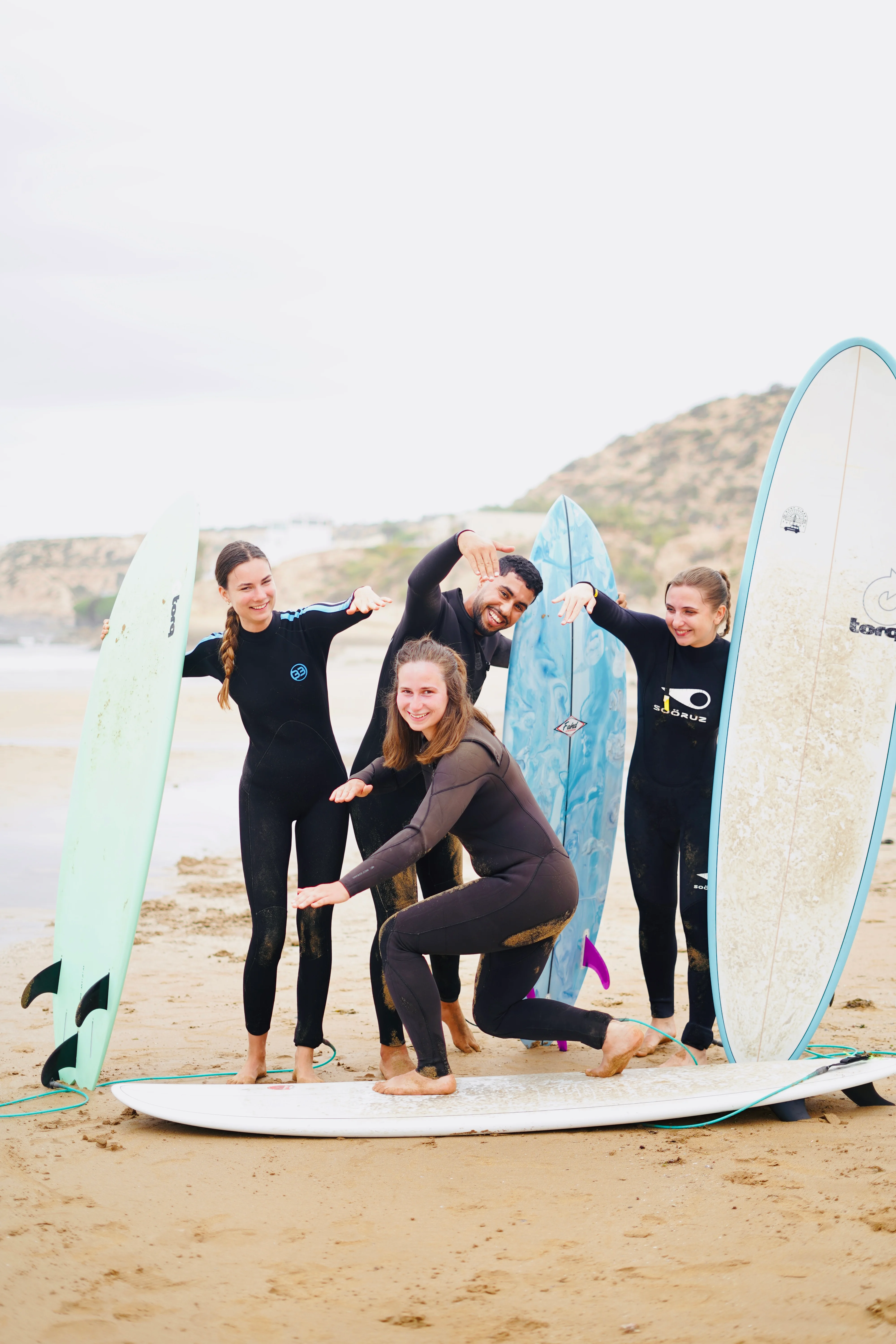 Group of surfers smiling at Tamraght beach