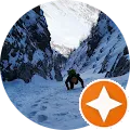 a man walking up a snow covered mountain