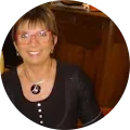 a woman wearing glasses and a black shirt