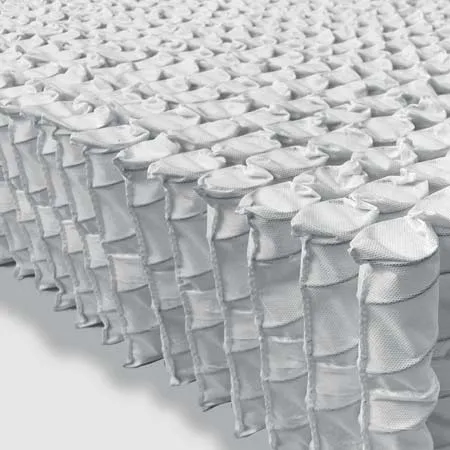 a bed covered in white ruffled sheets