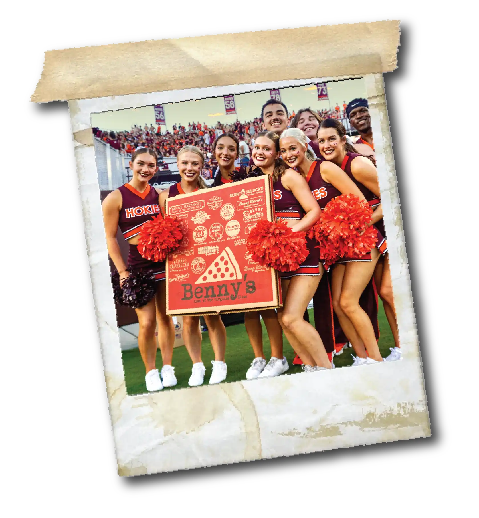 Cheerleaders in maroon Hokies uniforms holding a large Benny's pizza box on a football field.