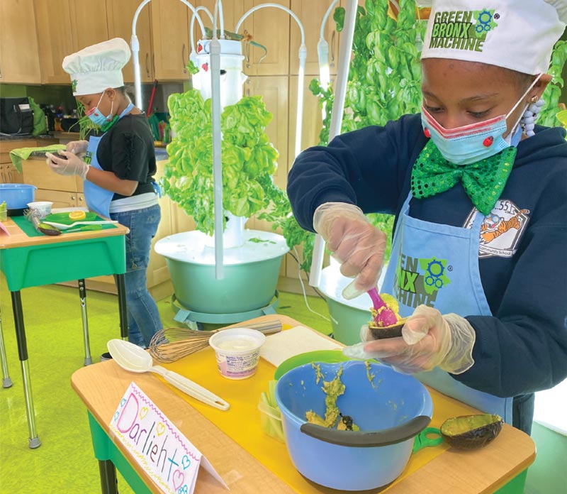 Families cooking together with produce grown at school