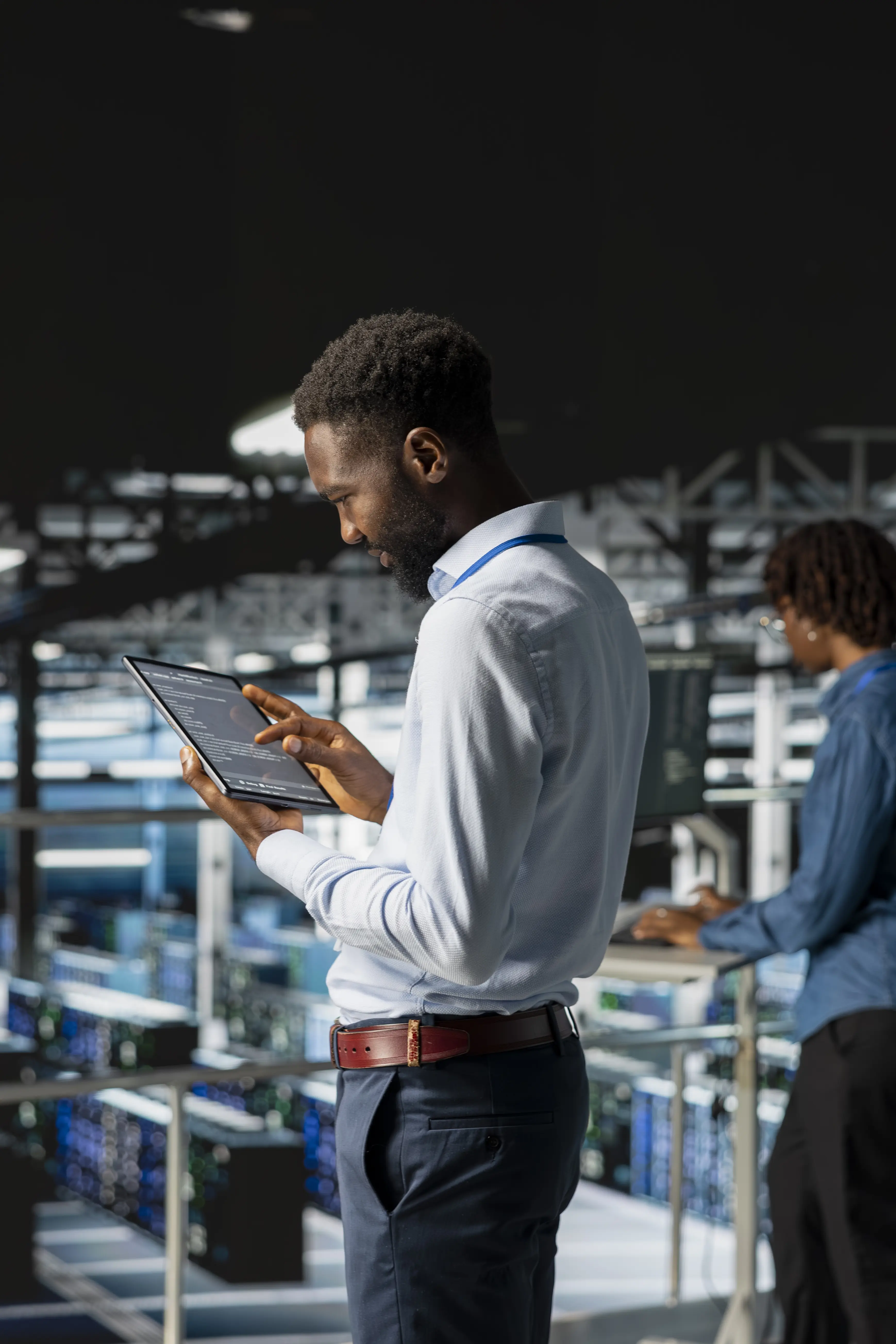 AI technician analyzing data center performance on a tablet for business automation solutions