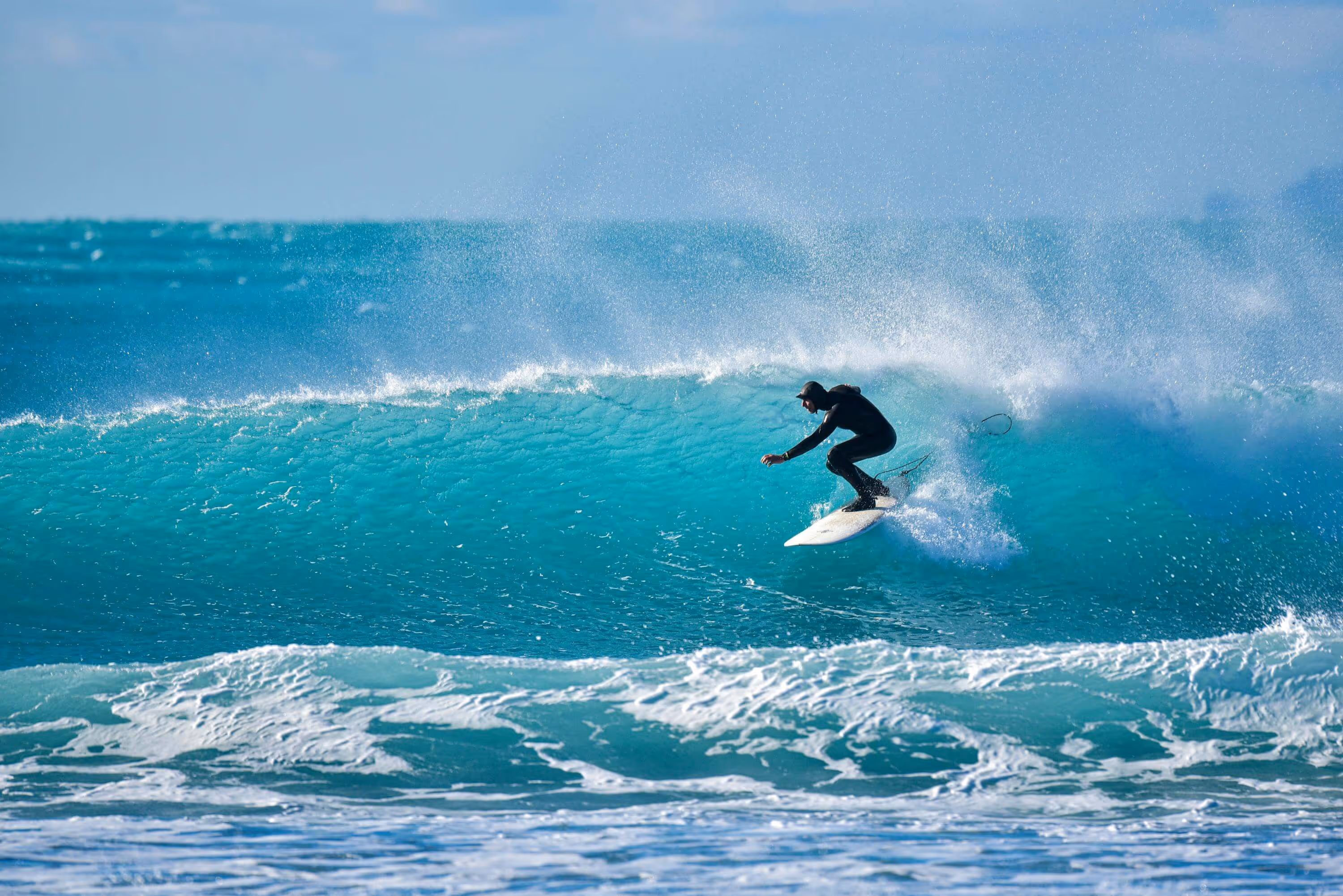 Surfer on surfboard catching a wave