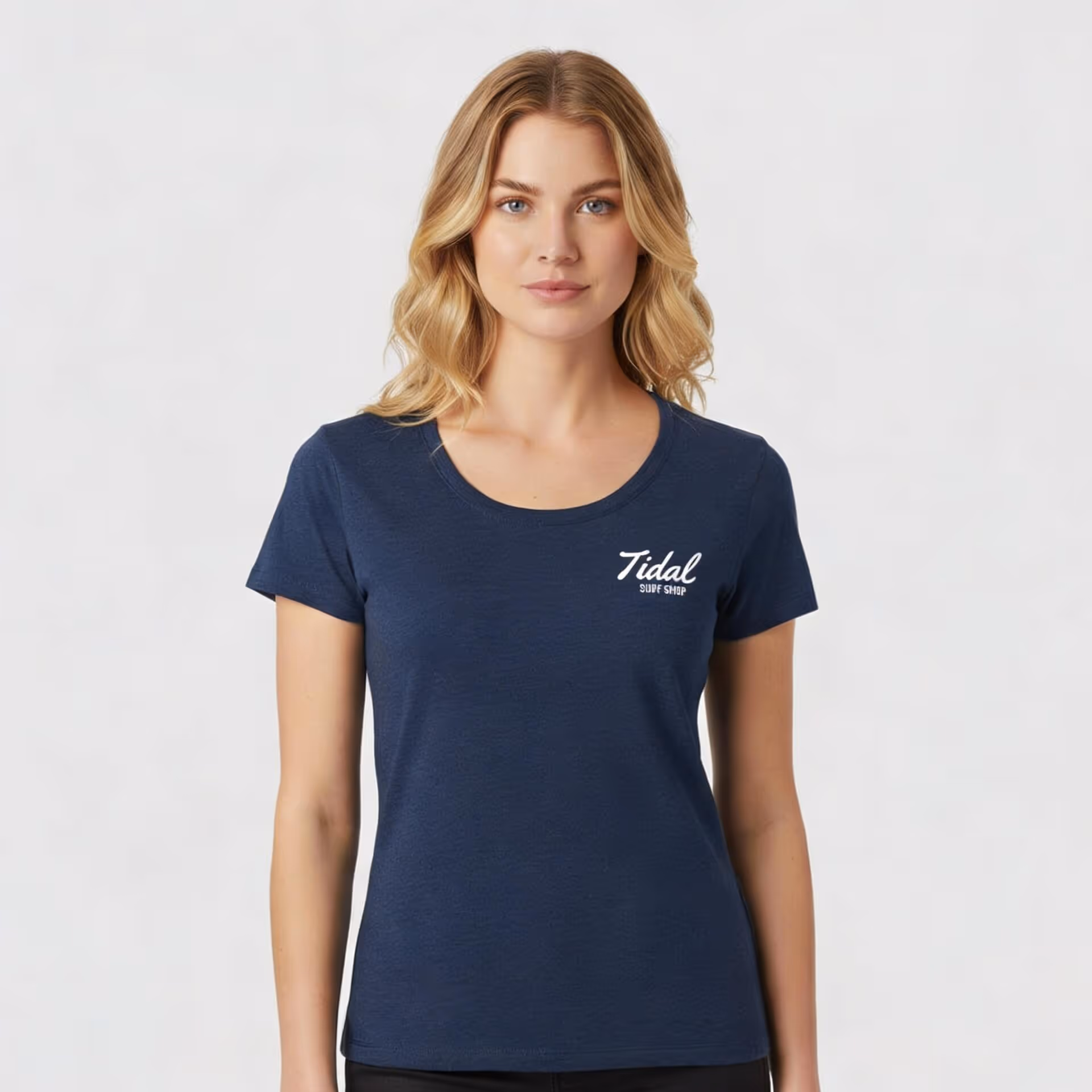 Woman wearing a navy blue fitted T-shirt with white 'Tidal Surf Shop' text on chest.