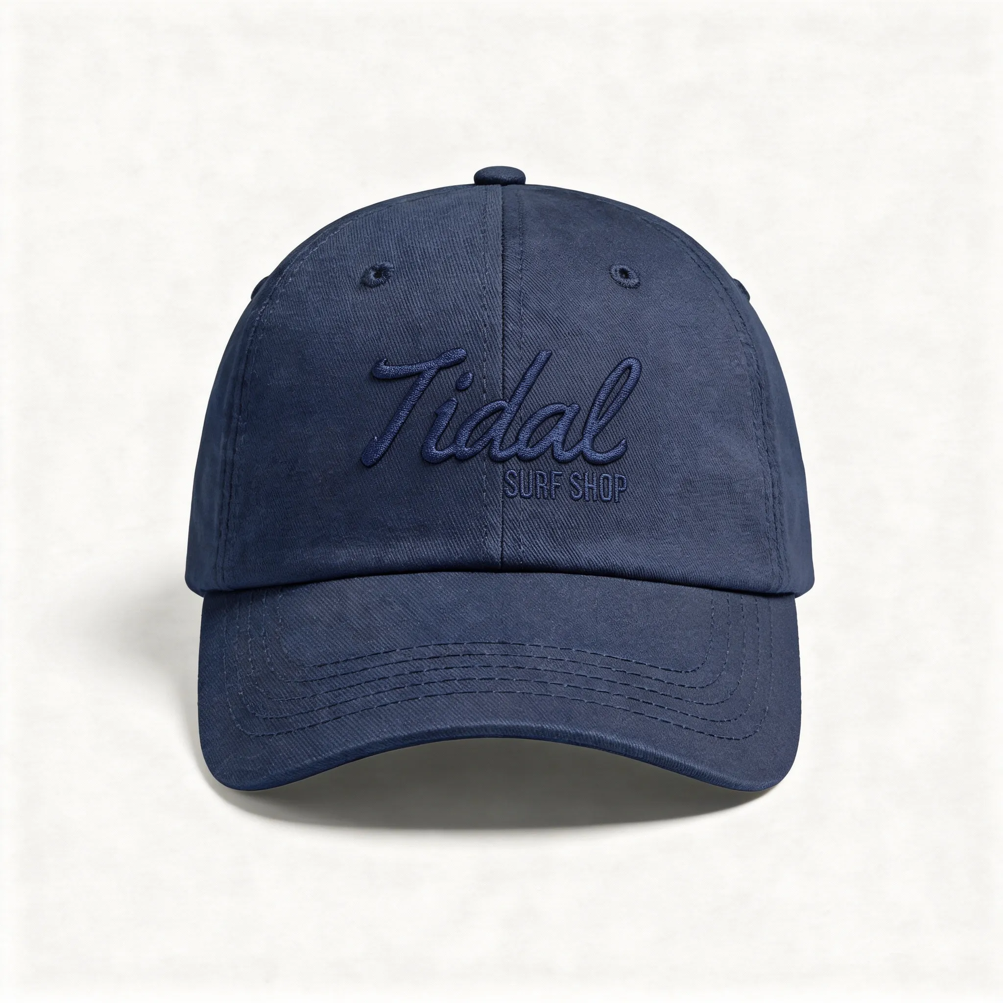 Navy blue baseball cap with embroidered text 'Tidal Surf Shop' on front.