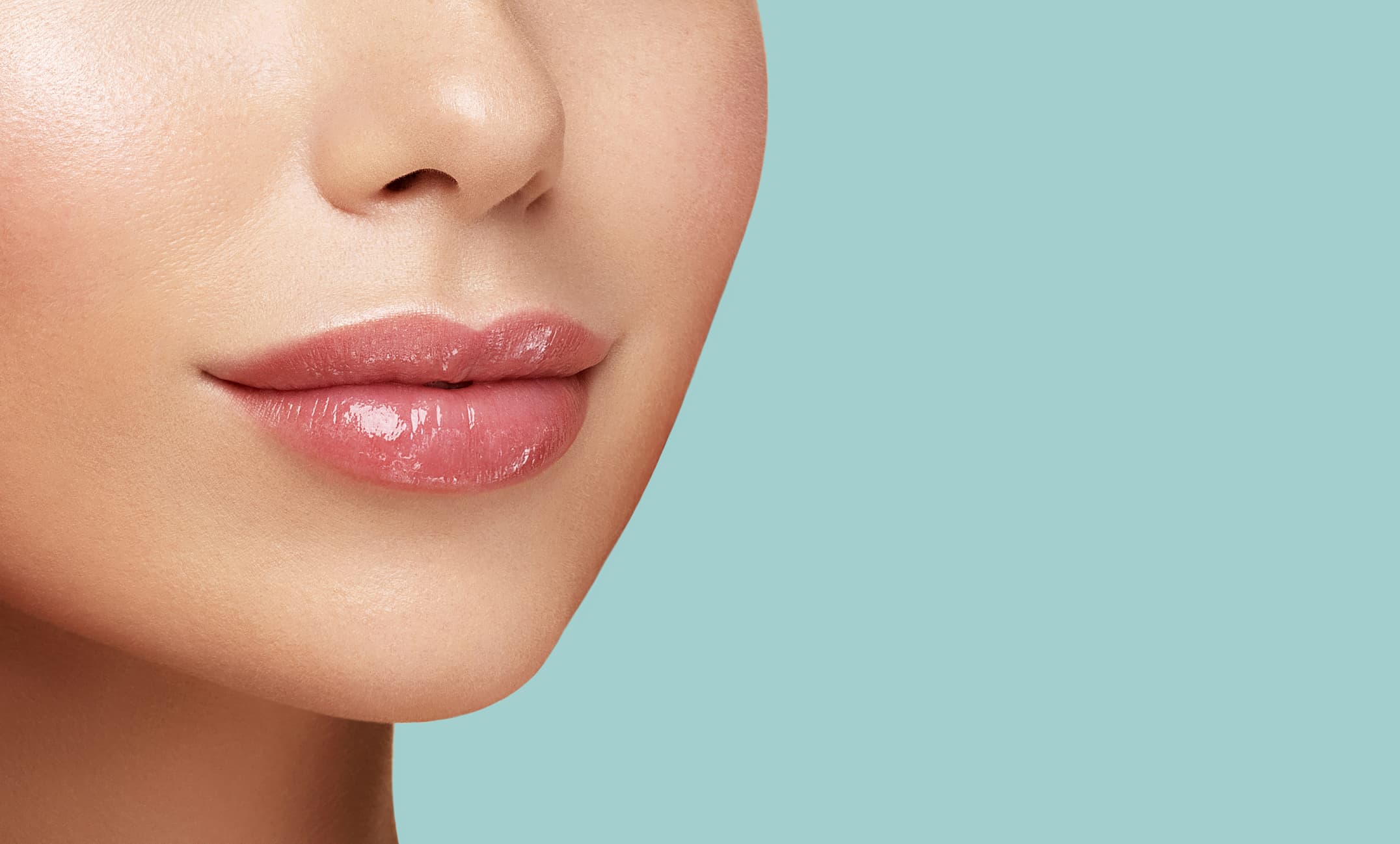 A close up of a woman's face with a blue background.
