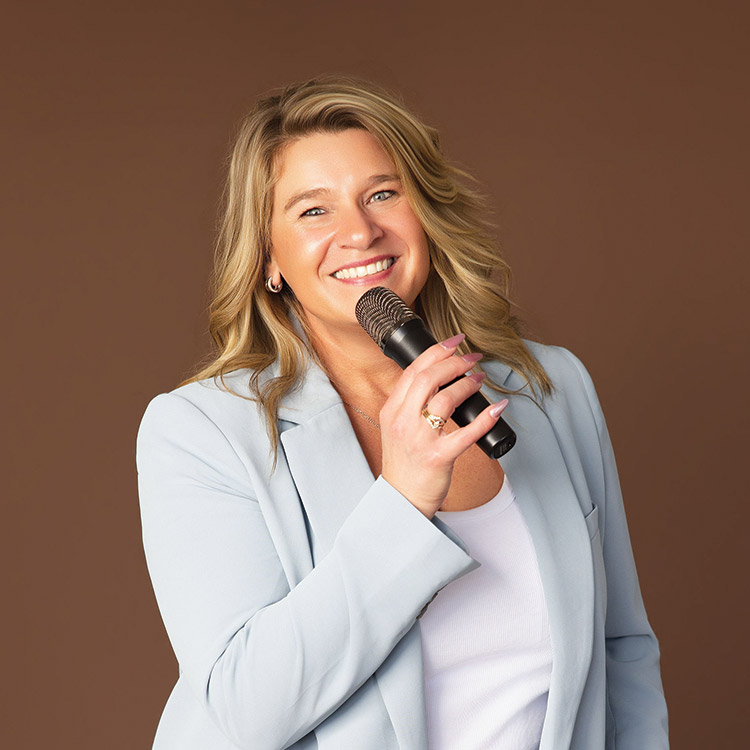 Tamiko McGurk smiling and holding a microphone