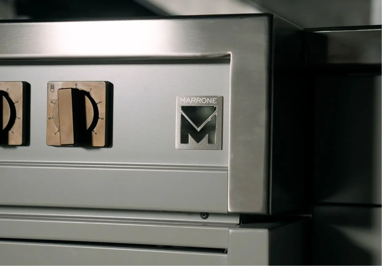 Close-up of the control panel of a stainless steel kitchen appliance with the brand name Marrone and two dials.