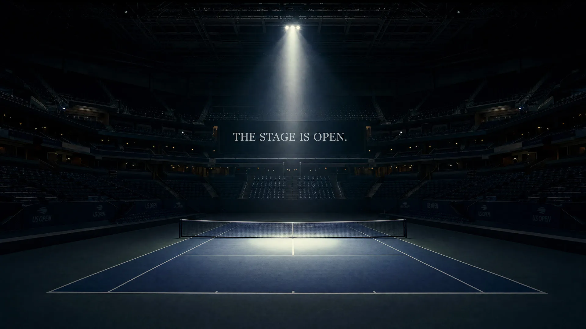 Empty tennis court lit by spotlight in a dark stadium with 'THE STAGE IS OPEN.' on the screen.