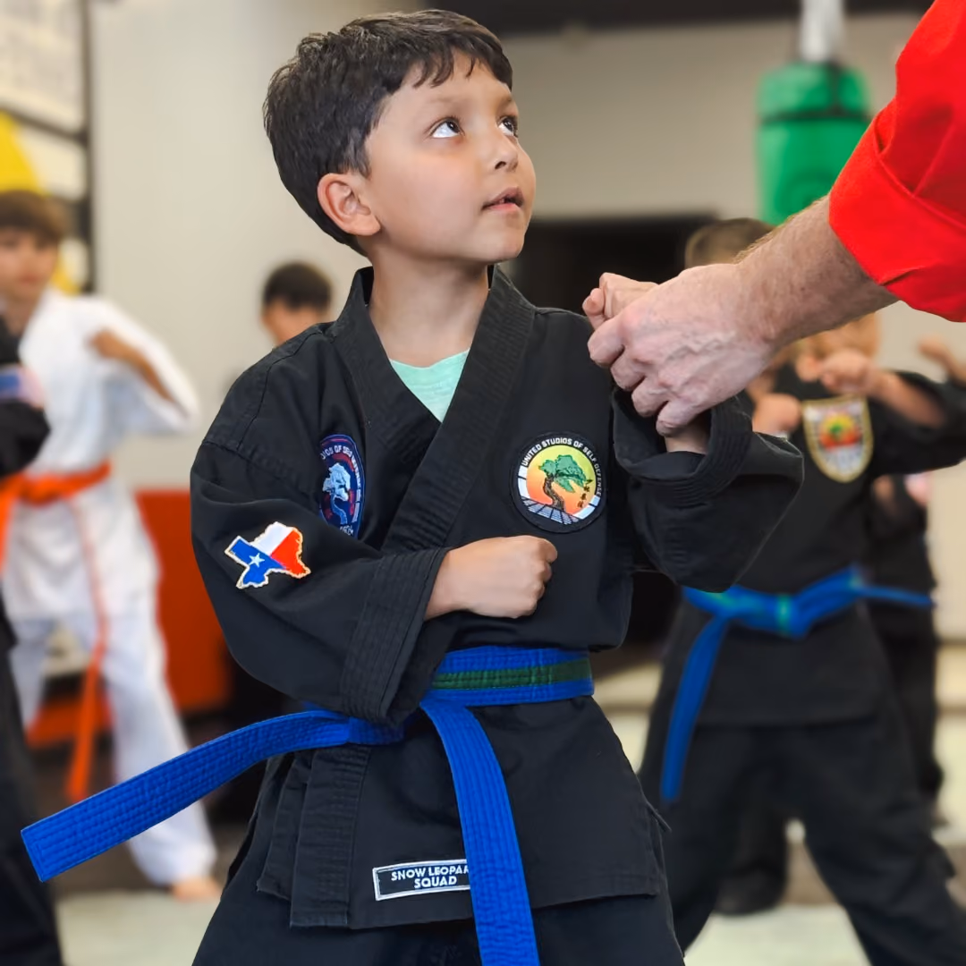 Young, Orange Belt Karate Student with his hands ready.