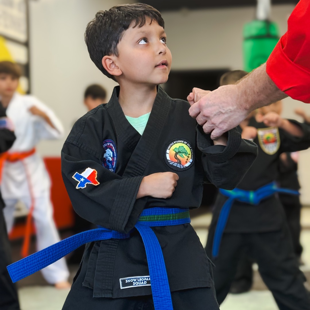 Young, Orange Belt Karate Student with his hands ready.