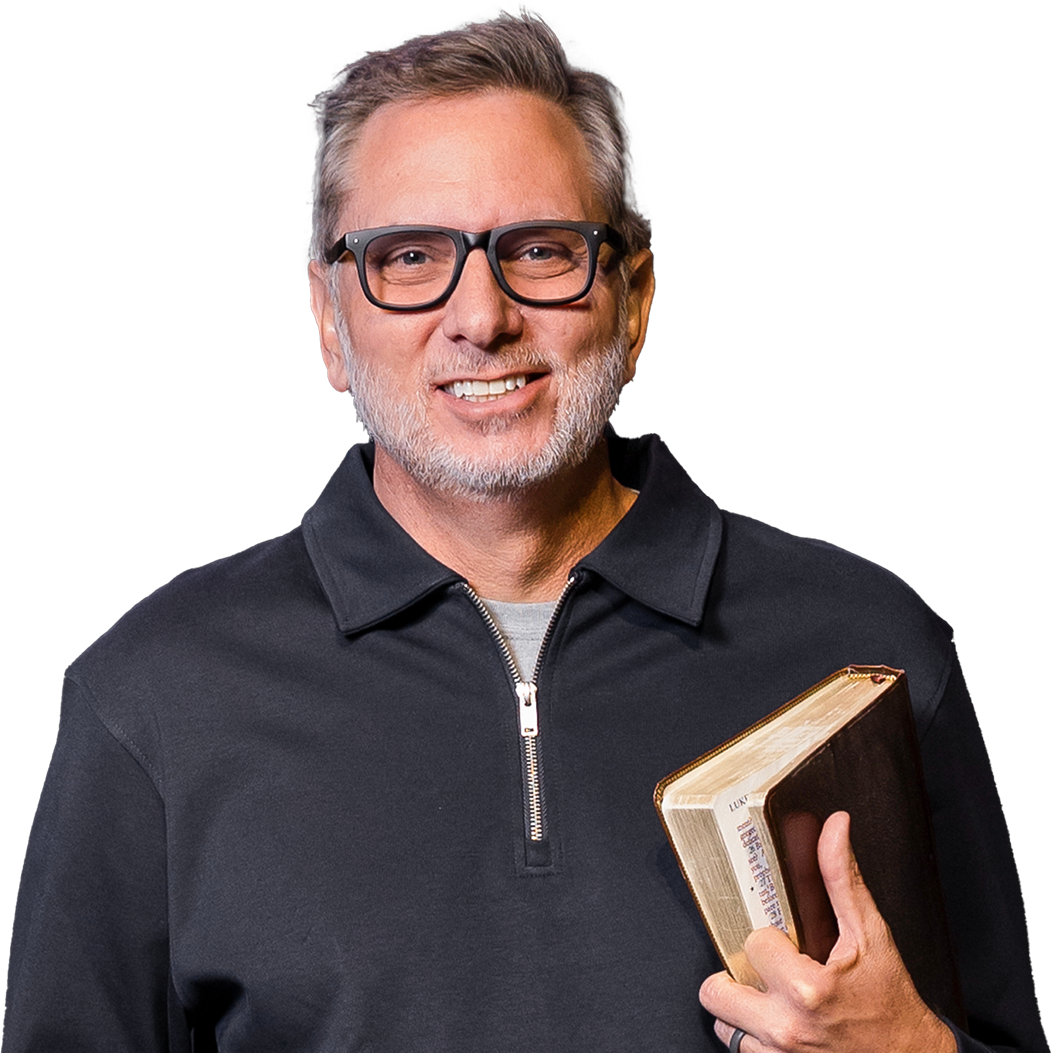 Rusty George smiling, holding a Bible