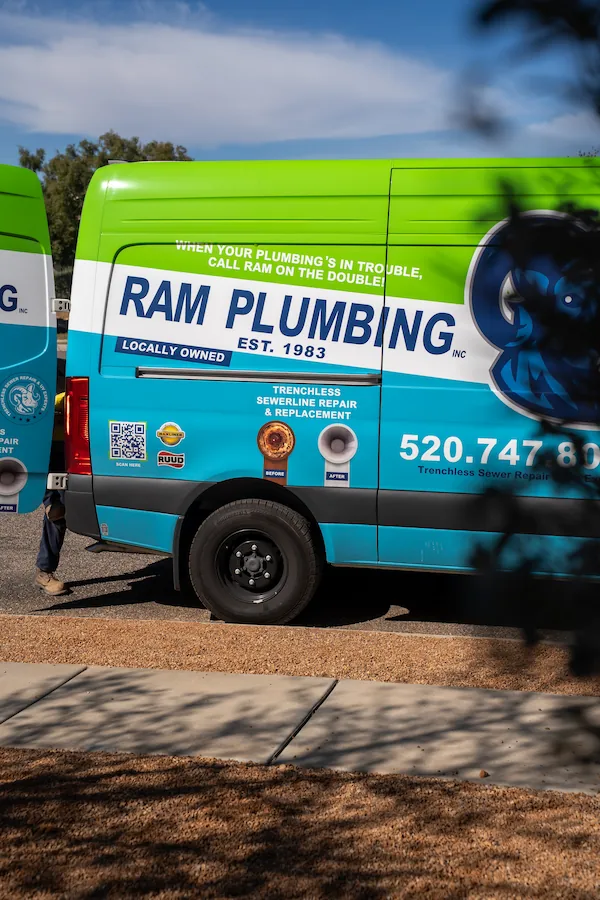Side view of RAM Plumbing van advertising trenchless sewerline repair and replacement services.