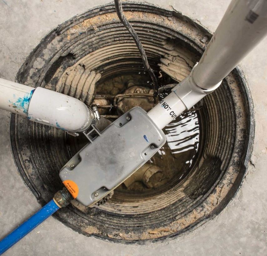 Sump pump installation services in Tucson AZ - professional installation of sump pump system in basement pit with pipe connections