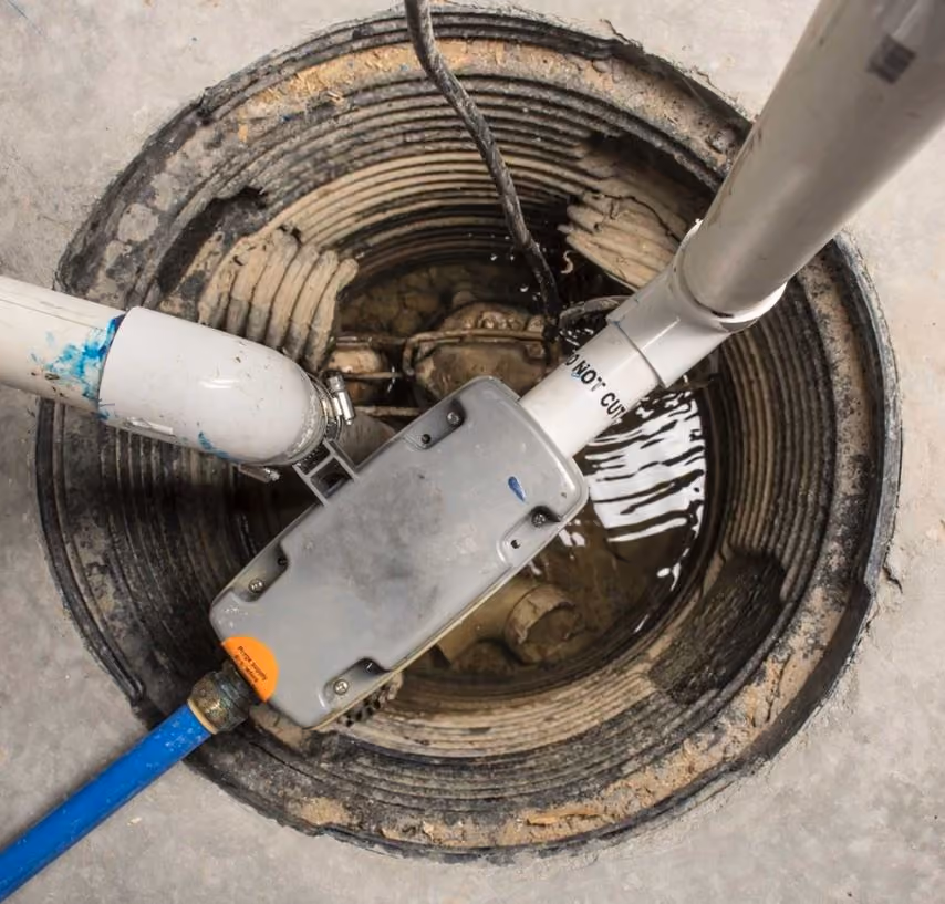 Sump pump installation services in Tucson AZ - professional installation of sump pump system in basement pit with pipe connections