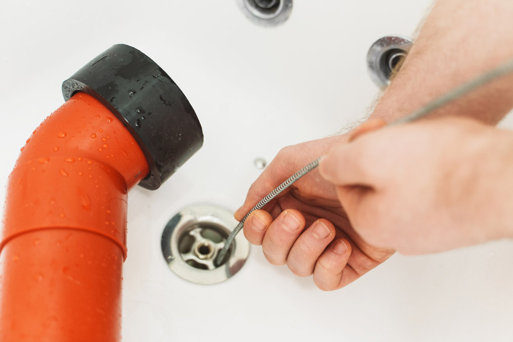 plumber cleaning drains
