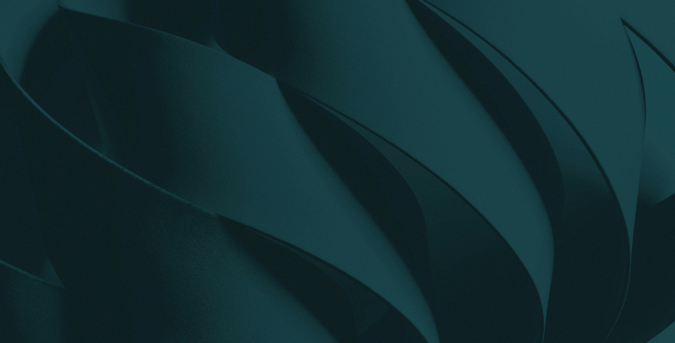Close-up of layered, curved teal paper or fabric creating abstract wave-like patterns.