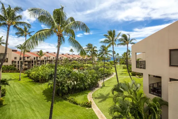 Lawns, palms and the red-roofed wings of Kamaole Sands in Kīhei