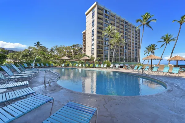Royal Kahana tower above its oceanfront pool in Kahana