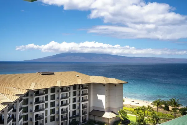 A Honua Kai tower above Kāʻanapali North Beach, with Lānaʻi across the channel