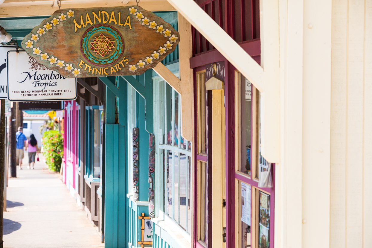 Colorful storefronts along a sidewalk in Paia town