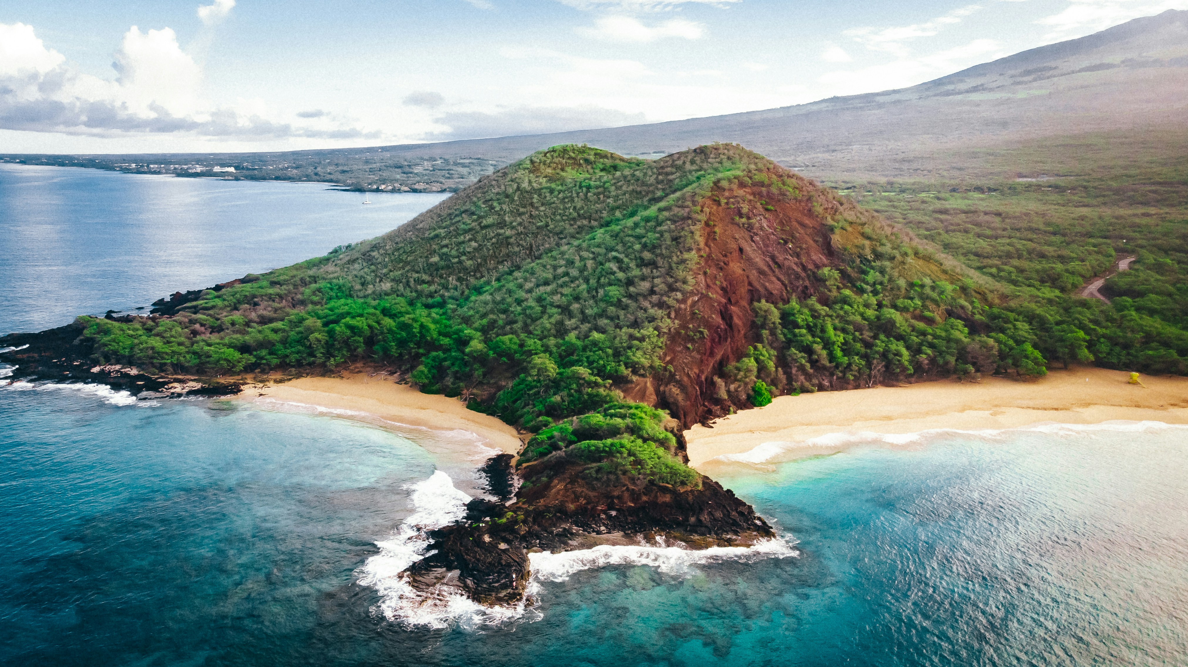 Big Beach at Mākena, a long curve of golden sand meeting turquoise water below lava headlands