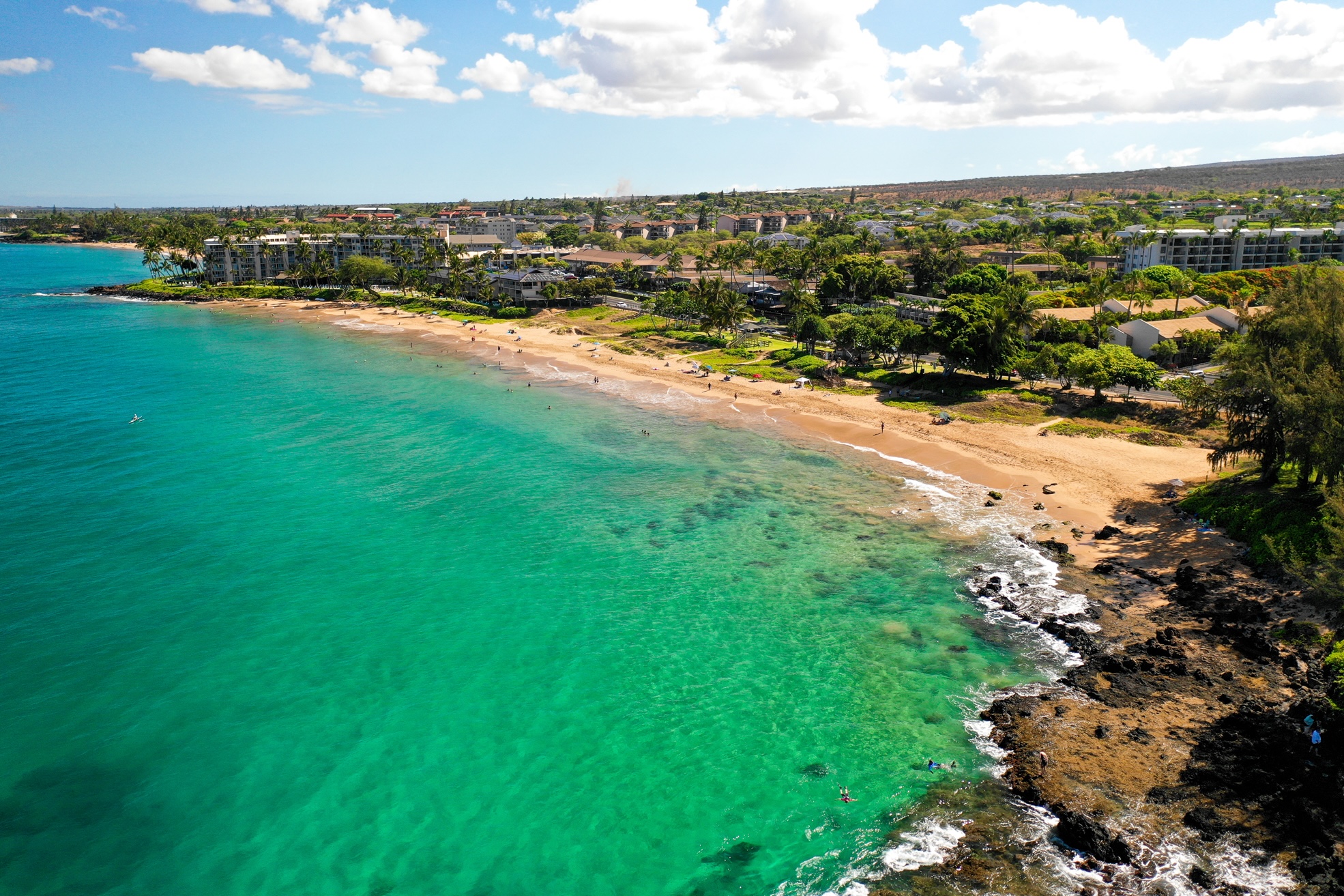 Kamaole Beach Park II in Kihei seen from the air, turquoise water over reef and a curve of pale sand