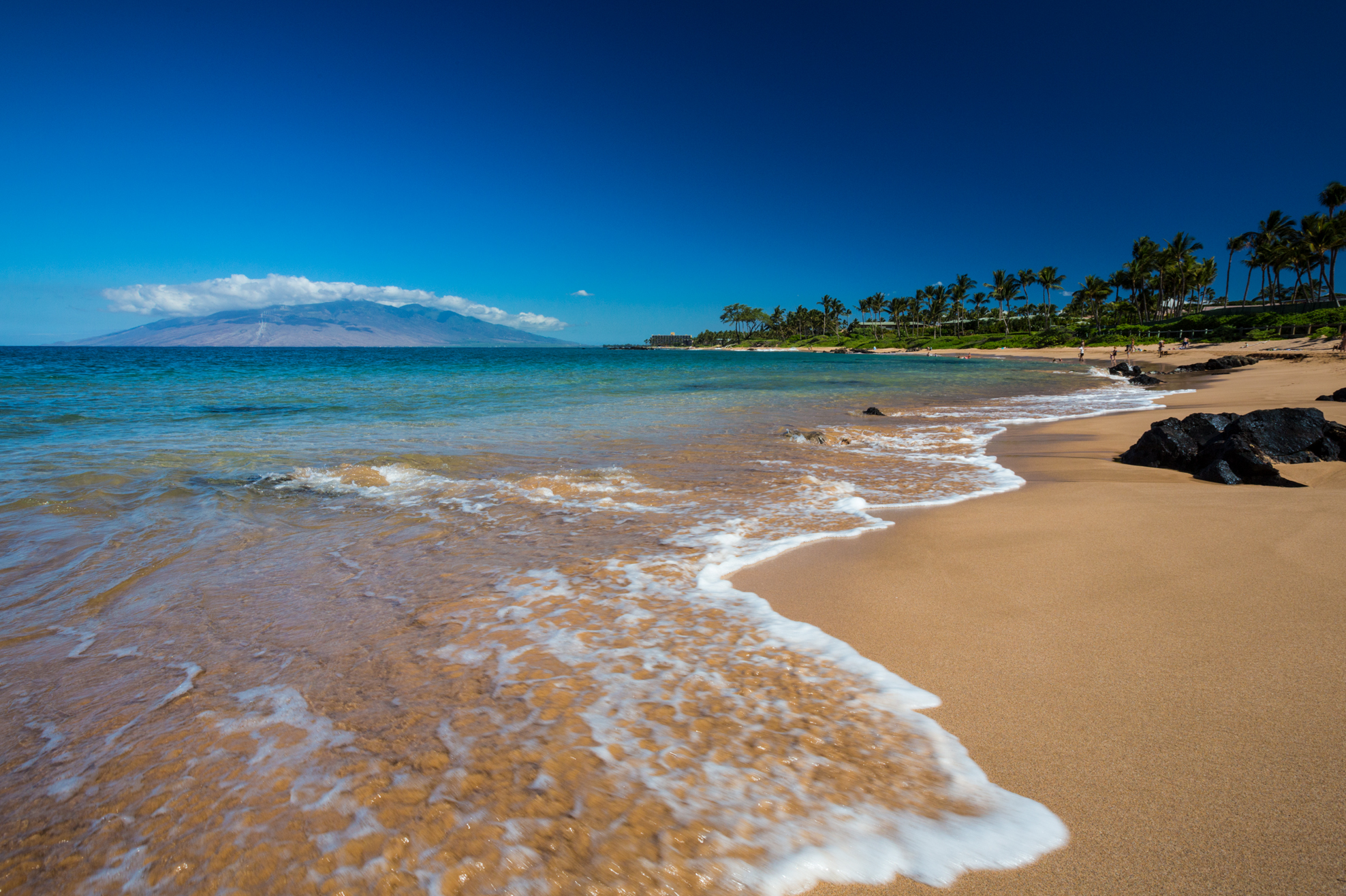 Mōkapu Beach in Wailea, a short curve of sand between two rocky points