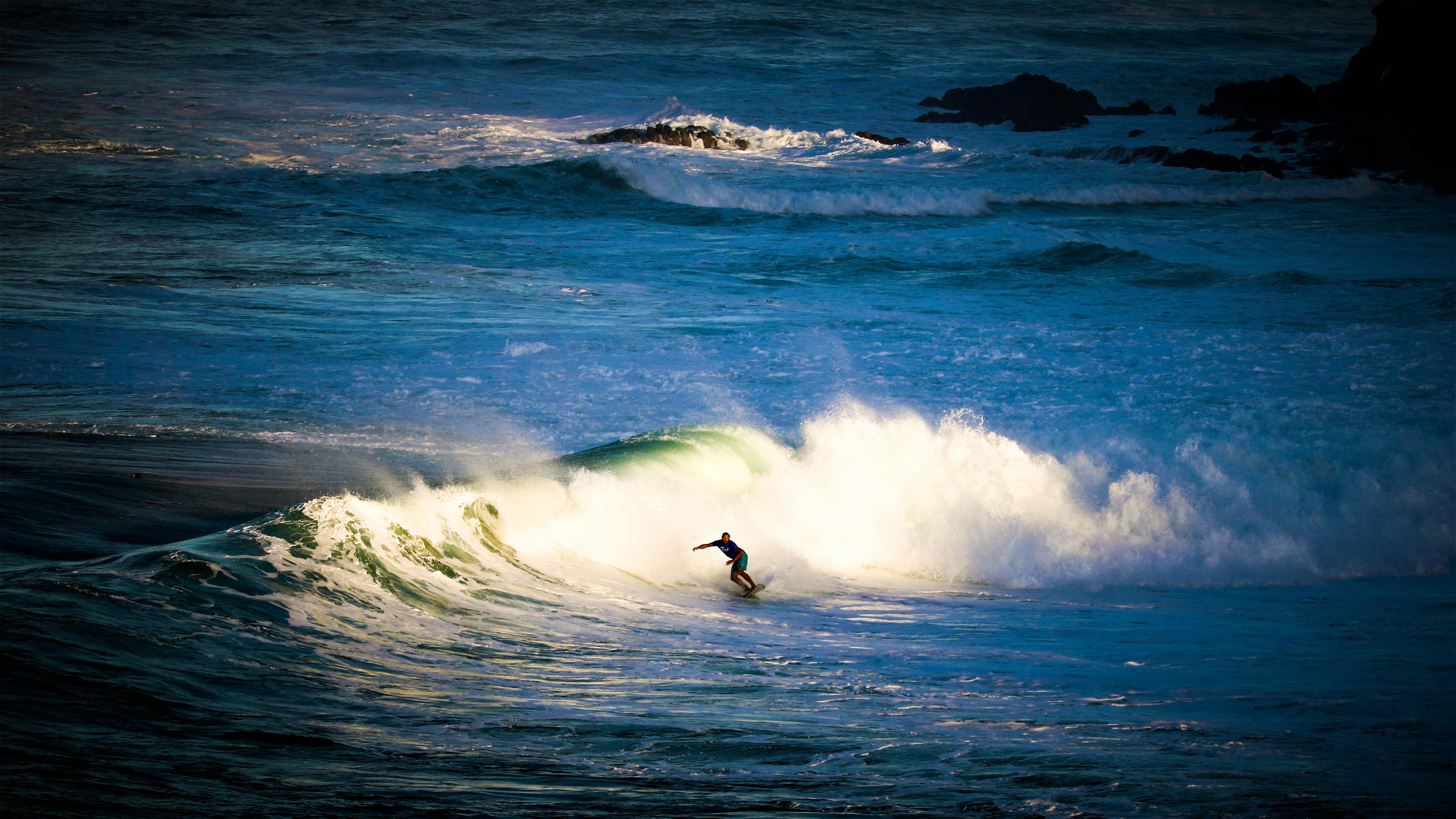 A surfer riding a wave on Maui's north shore