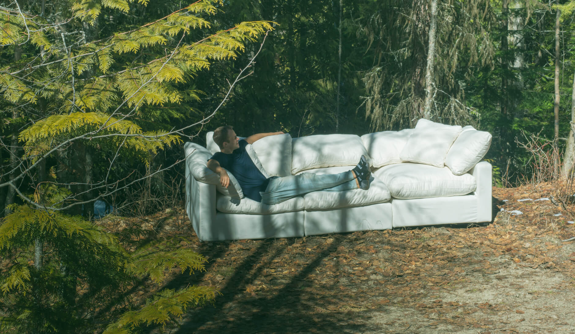 Designer sitting on the Luun sofa
