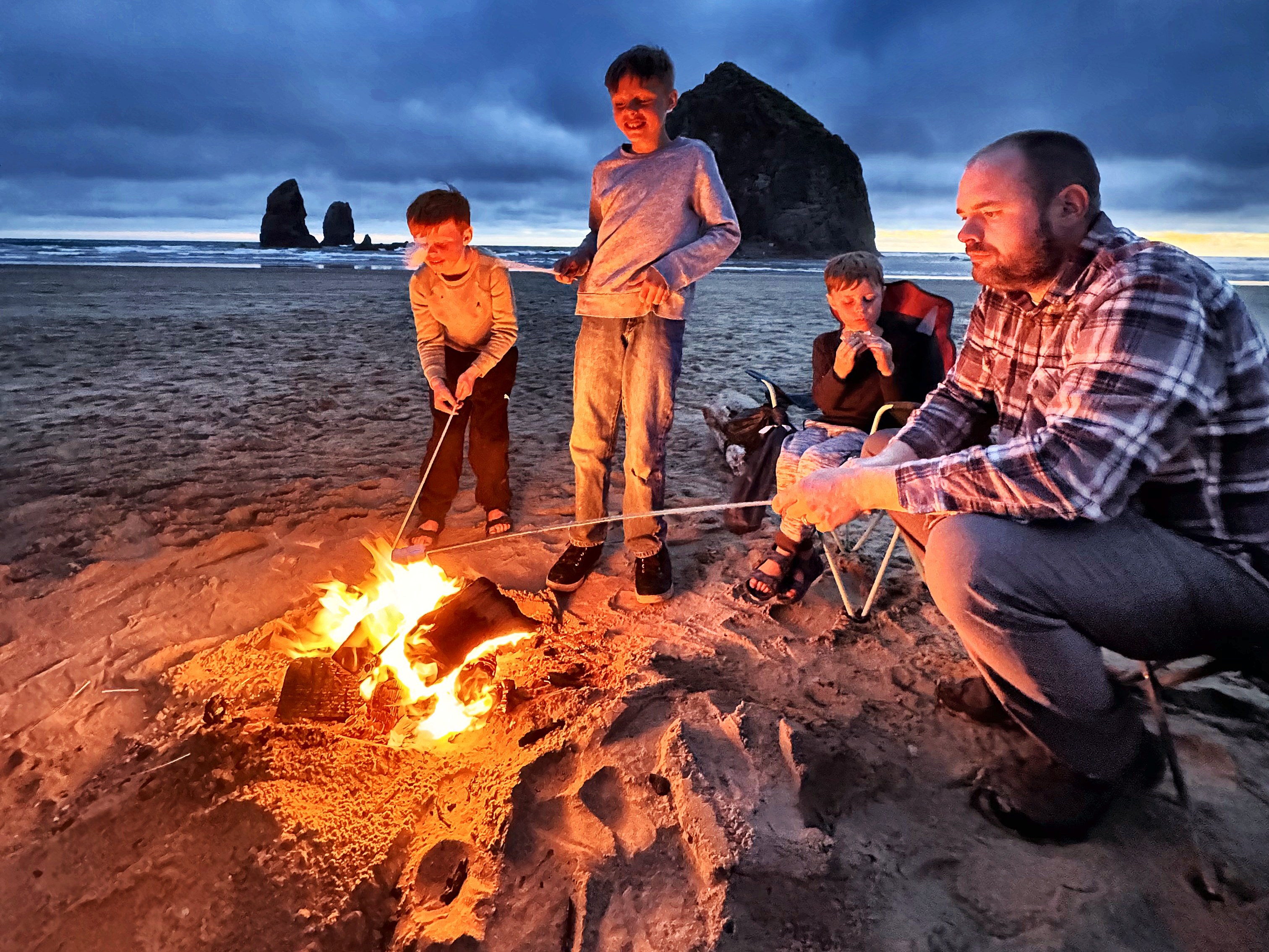 Beach campfire at dusk below Haystack Rock, Cannon Beach
