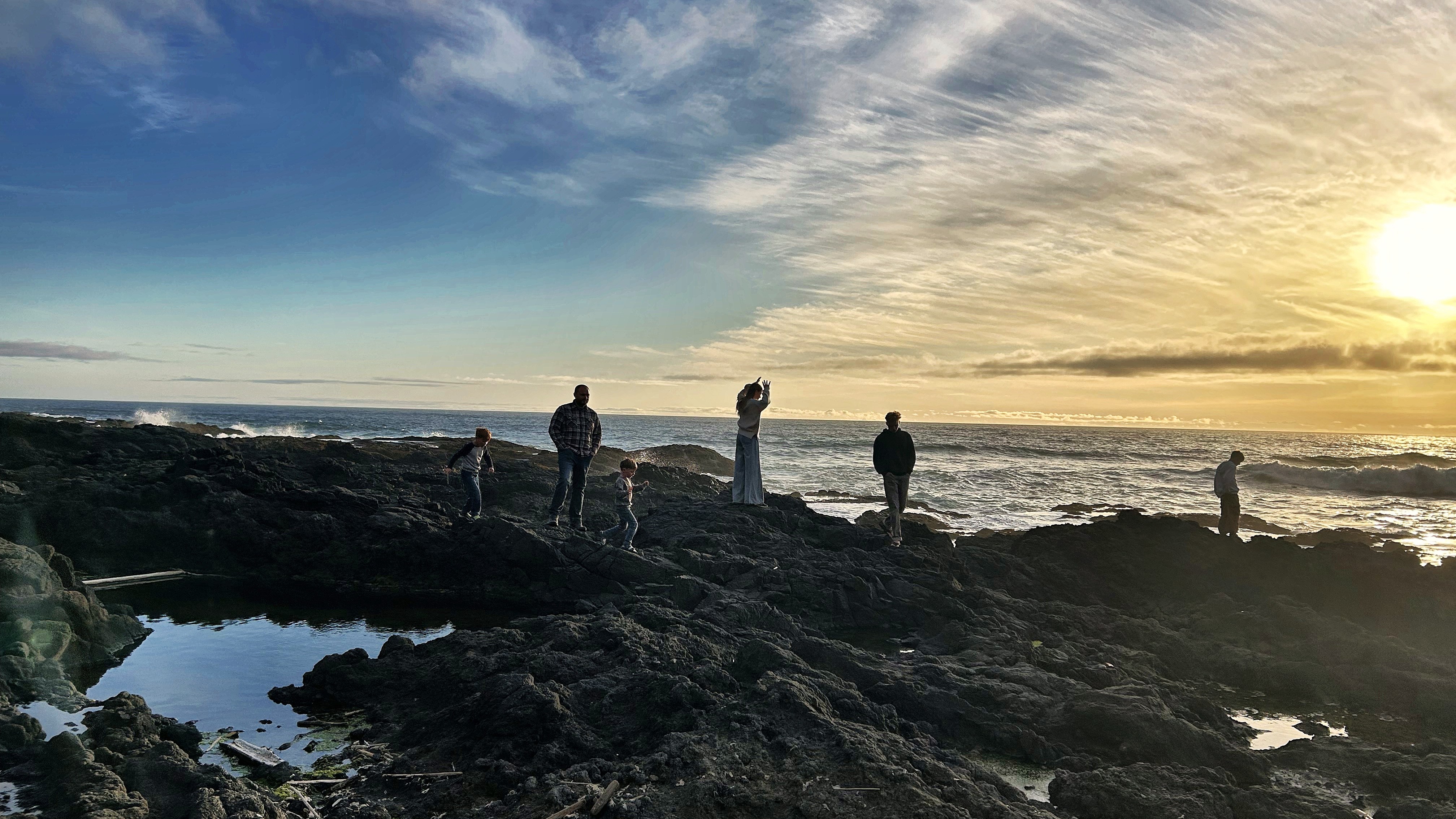 Family silhouettes on the Cape Perpetua tide pools at sunset, Oregon Central Coast