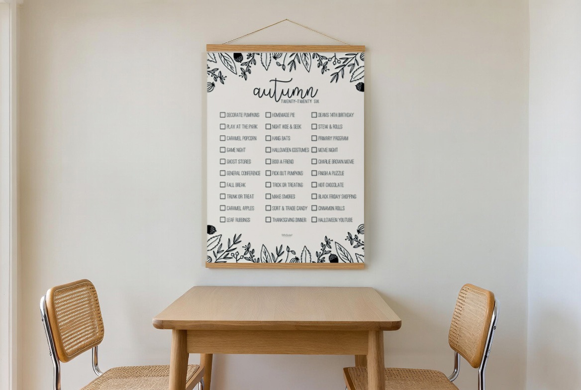 Autumn Leaves bucket list print hanging in a living room