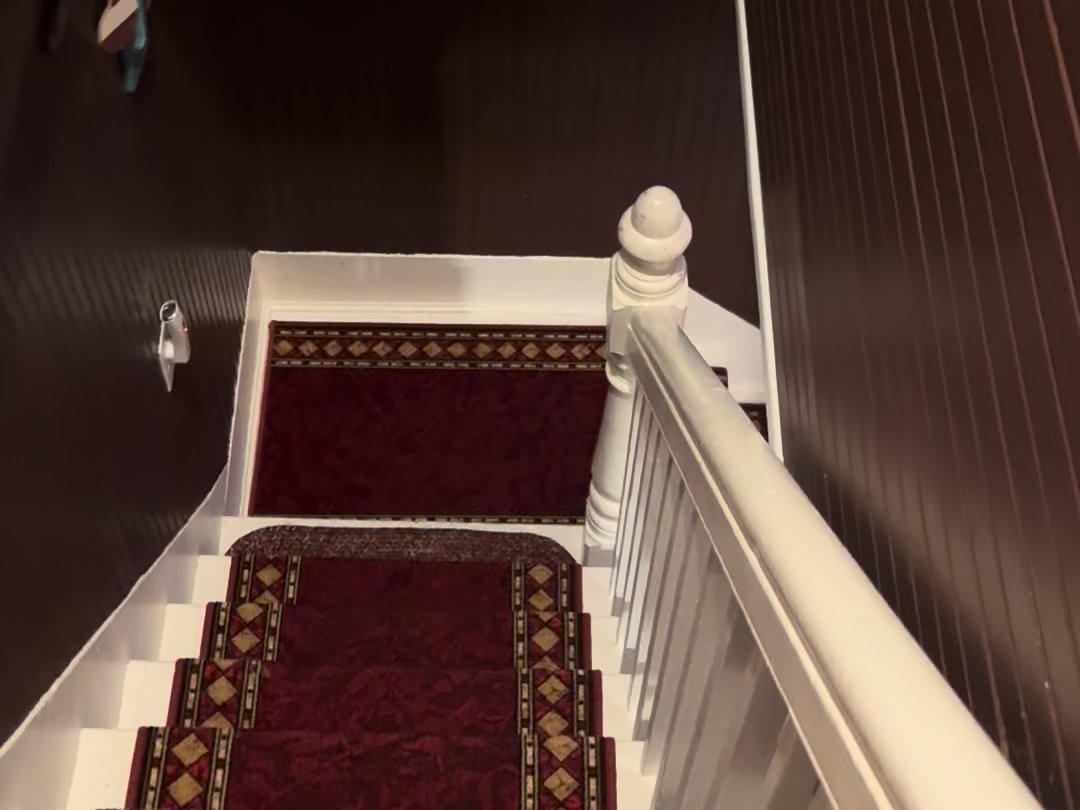 The staircase in the Swan House with a red patterned runner