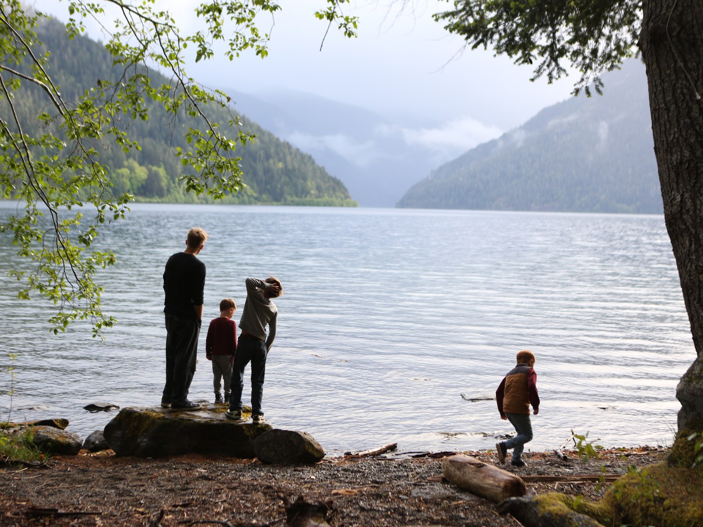 Amy's family at the edge of Lake Crescent, framed by trees