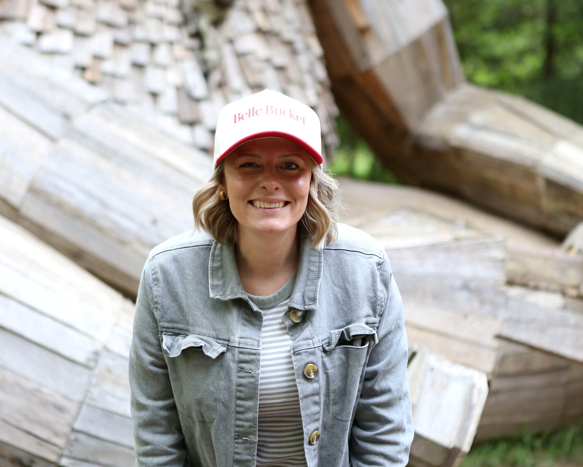 Amy in her Belle Bucket cap in front of one of the Northwest trolls